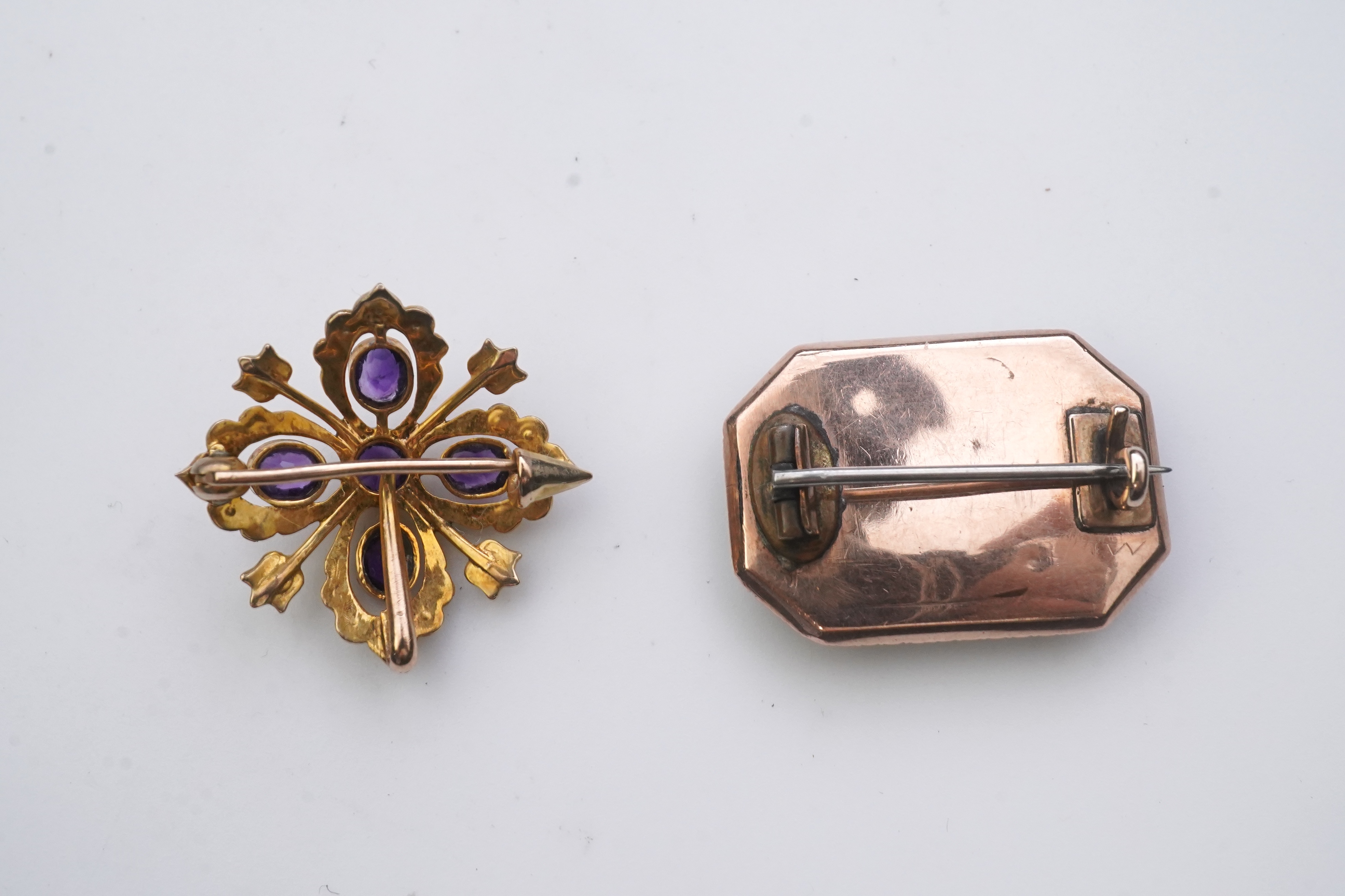 A Georgian mourning brooch, early 19th century, two Edwardian pendants, early 20th century